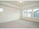 Spacious bedroom with natural light features neutral carpet, white walls, and tray ceilings at 267 Parkland Dr Dr, Pittsboro, NC 27312
