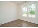 Sunlit bedroom with wood-look floors and large windows overlooking the backyard at 267 Parkland Dr Dr, Pittsboro, NC 27312