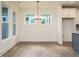 Bright dining room features hardwood floors, white walls and trim, and modern chandelier at 267 Parkland Dr Dr, Pittsboro, NC 27312