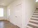 Bright entryway featuring wood-look floors, white trim, and a staircase to the upper level at 267 Parkland Dr Dr, Pittsboro, NC 27312