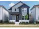 Charming two-story home with a covered porch, gray siding, and modern design at 267 Parkland Dr Dr, Pittsboro, NC 27312
