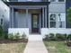 Inviting front porch with painted brick, a modern front door, and well-maintained landscaping at 267 Parkland Dr Dr, Pittsboro, NC 27312
