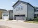 Exterior shot of a large two-car garage with a gray door and light gray siding at 267 Parkland Dr Dr, Pittsboro, NC 27312