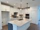 Bright, modern kitchen with white cabinets, stainless steel appliances, and a large center island at 267 Parkland Dr Dr, Pittsboro, NC 27312