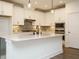 Kitchen features white cabinets, stainless appliances, backsplash, and a large central island at 267 Parkland Dr Dr, Pittsboro, NC 27312