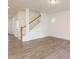 Open-concept living room with wood-look floors and a staircase, offering versatile living space at 267 Parkland Dr Dr, Pittsboro, NC 27312