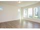 Bright living room with wood-look floors, large windows, and ample natural light at 267 Parkland Dr Dr, Pittsboro, NC 27312