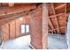 Exposed wooden attic with brick chimney, revealing the bones of the home at 301 Hillsborough St, Chapel Hill, NC 27514