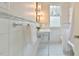 Bathroom features a pedestal sink, stylish fixtures, and subway tile with marble accents at 301 Hillsborough St, Chapel Hill, NC 27514