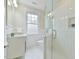 Modern bathroom with a glass shower, white vanity, and stylish hexagonal tile flooring at 301 Hillsborough St, Chapel Hill, NC 27514