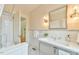 Elegant bathroom features a pedestal sink, stylish fixtures, and subway tile with view to the hallway at 301 Hillsborough St, Chapel Hill, NC 27514