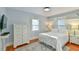 Bright bedroom features hardwood floors, lots of natural light, and simple white furniture at 301 Hillsborough St, Chapel Hill, NC 27514