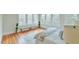 Bright bedroom featuring large windows, hardwood floors, and a floral-patterned bed at 301 Hillsborough St, Chapel Hill, NC 27514