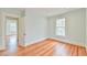 Bright bedroom with hardwood floors and natural light, featuring a calming blue palette at 301 Hillsborough St, Chapel Hill, NC 27514