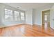 Spacious bedroom with hardwood floors, closet, and open doorway to another room at 301 Hillsborough St, Chapel Hill, NC 27514
