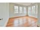 Bright bedroom with hardwood floors and multiple windows providing natural light at 301 Hillsborough St, Chapel Hill, NC 27514