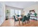 An elegant dining room filled with natural light, featuring hardwood floors and comfortable seating at 301 Hillsborough St, Chapel Hill, NC 27514