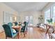 Sunlit dining area boasts hardwood floors, large windows, and stylish decor at 301 Hillsborough St, Chapel Hill, NC 27514