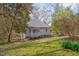 Quaint home with a covered front porch surrounded by mature trees and a lush green lawn at 301 Hillsborough St, Chapel Hill, NC 27514