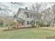 Classic home featuring a covered porch, manicured lawn, and mature trees at 301 Hillsborough St, Chapel Hill, NC 27514