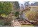 Inviting home exterior featuring a stone walkway, mature landscaping, and a charming covered porch at 301 Hillsborough St, Chapel Hill, NC 27514