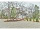 Exterior of home with gravel driveway and lush landscaping and large trees at 301 Hillsborough St, Chapel Hill, NC 27514