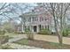 Charming two-story home with a landscaped front yard and flowering tree at 301 Hillsborough St, Chapel Hill, NC 27514