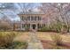 Inviting two-story home with stone walkway, lush landscaping, and blooming trees at 301 Hillsborough St, Chapel Hill, NC 27514