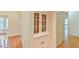 Hallway with built-in cabinetry leading to dining and living areas, hardwood floors at 301 Hillsborough St, Chapel Hill, NC 27514