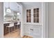 Hallway view of a kitchen with a breakfast bar and white shaker cabinets at 301 Hillsborough St, Chapel Hill, NC 27514