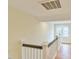 Upstairs hallway with white railing and hardwood floors showcasing natural light at 301 Hillsborough St, Chapel Hill, NC 27514