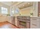 Well-lit kitchen showcasing stainless steel appliances, white cabinetry, and subway tile backsplash at 301 Hillsborough St, Chapel Hill, NC 27514