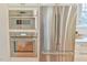 This kitchen features built-in stainless steel appliances and white cabinets with modern hardware at 301 Hillsborough St, Chapel Hill, NC 27514