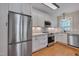 Modern kitchen featuring stainless steel appliances, white cabinetry, and light countertops at 301 Hillsborough St, Chapel Hill, NC 27514