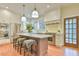 Bright kitchen boasts a center island with marble countertop, stainless steel appliances, and modern fixtures at 301 Hillsborough St, Chapel Hill, NC 27514