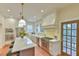 Bright kitchen boasts a center island with marble countertop, stainless steel appliances, and modern fixtures at 301 Hillsborough St, Chapel Hill, NC 27514