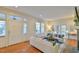 Spacious living room features a stone fireplace, hardwood floors, and front entry door at 301 Hillsborough St, Chapel Hill, NC 27514