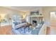 Bright living room features a stone fireplace, hardwood floors, and stylish furnishings at 301 Hillsborough St, Chapel Hill, NC 27514
