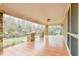 Expansive covered porch features stone columns and wood floors with neighborhood views at 301 Hillsborough St, Chapel Hill, NC 27514