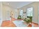 Cozy sitting area features hardwood floors and access to other rooms at 301 Hillsborough St, Chapel Hill, NC 27514