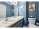 Stylish bathroom with blue walls, vanity and a modern sink at 304 Briarwood Dr, Mebane, NC 27302
