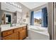 Bright bathroom with a bathtub, large window, and ample counter space at 304 Briarwood Dr, Mebane, NC 27302