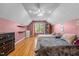 Cozy bedroom with two twin beds, hardwood floors, and natural light from a large window at 304 Briarwood Dr, Mebane, NC 27302