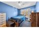 Comfortable bedroom with a wooden bed frame, carpeted floors, and natural light from a large window at 304 Briarwood Dr, Mebane, NC 27302