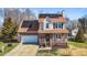 Charming two-story home with brick facade, front porch, solar panels and manicured landscaping at 304 Briarwood Dr, Mebane, NC 27302