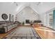 Bright living room with vaulted ceiling, fireplace, hardwood floors, and large area rug at 304 Briarwood Dr, Mebane, NC 27302