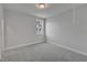 This bedroom features neutral walls, carpet, and trim, along with a window that offers a natural light source at 3200 Balcon Ct # 28, Angier, NC 27501