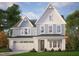 Two-story house featuring vertical siding, decorative gables, white-framed windows, and a well-manicured lawn at 3200 Balcon Ct # 28, Angier, NC 27501