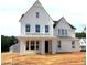 New two-story home showcasing a white exterior, a covered porch with columns, and multiple windows at 3200 Balcon Ct # 28, Angier, NC 27501
