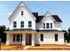 New two-story home with white siding, black roof and trim, and a welcoming front porch at 3200 Balcon Ct # 28, Angier, NC 27501